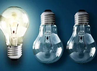 Five lightbulbs, with only one turned on.